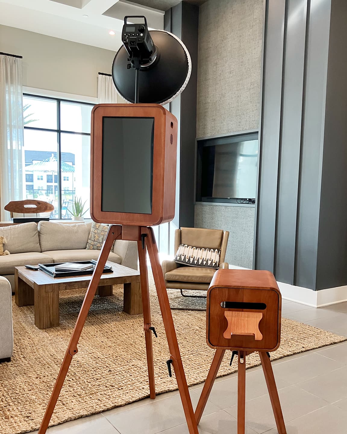 Luxury wooden wedding photo booth and matching printer setup in a modern Tampa event lounge