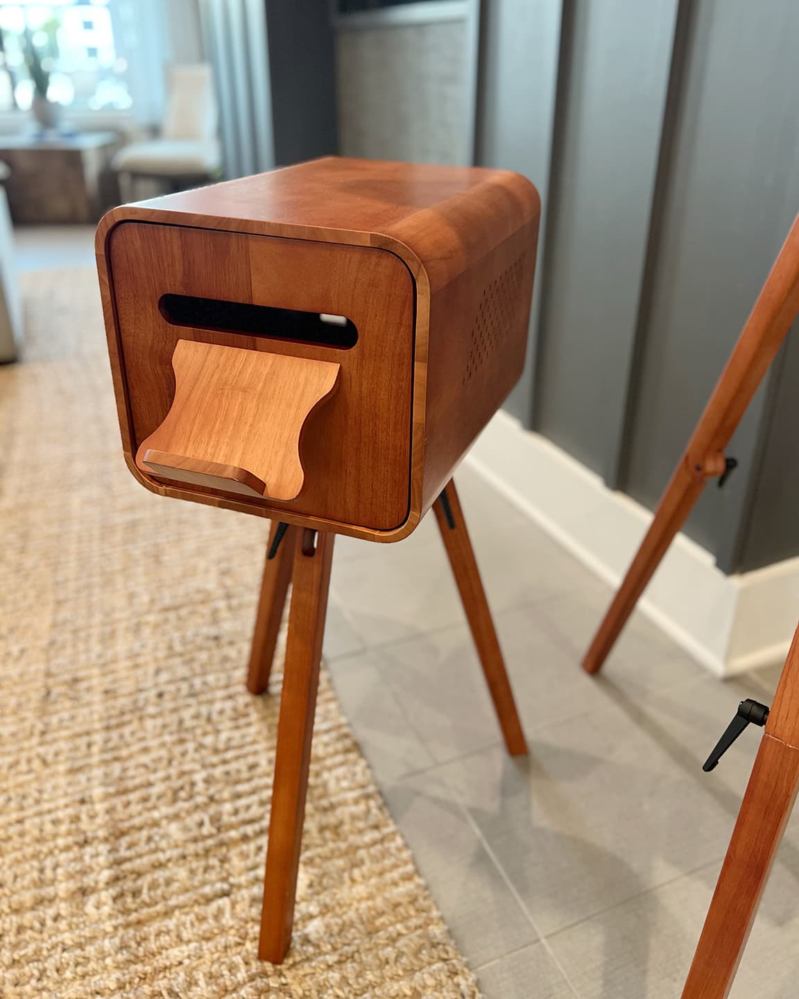 Sleek modern wooden photo booth with a retro design on a matching tripod stand, available for Wesley Chapel photo booth rental