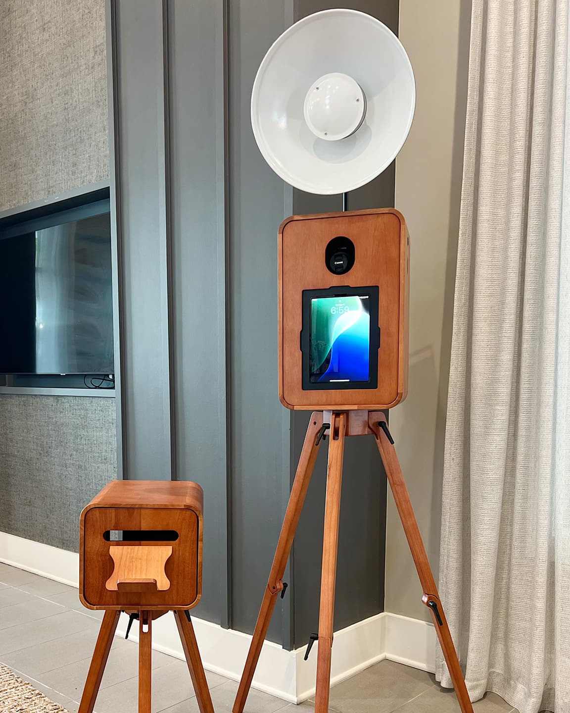 Luxury wooden photo booth with iPad interface and professional lighting next to a matching printer station for Tampa rustic photo booth rental